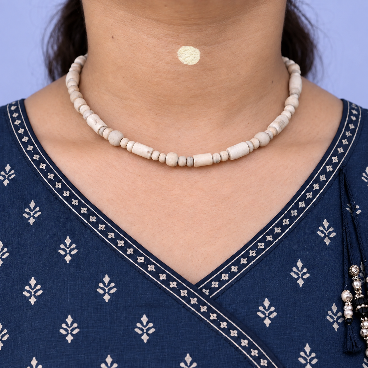 Tulsi kanthi mala with cylindrical beads, larger round beads and small spacers worn with a navy printed kurta.