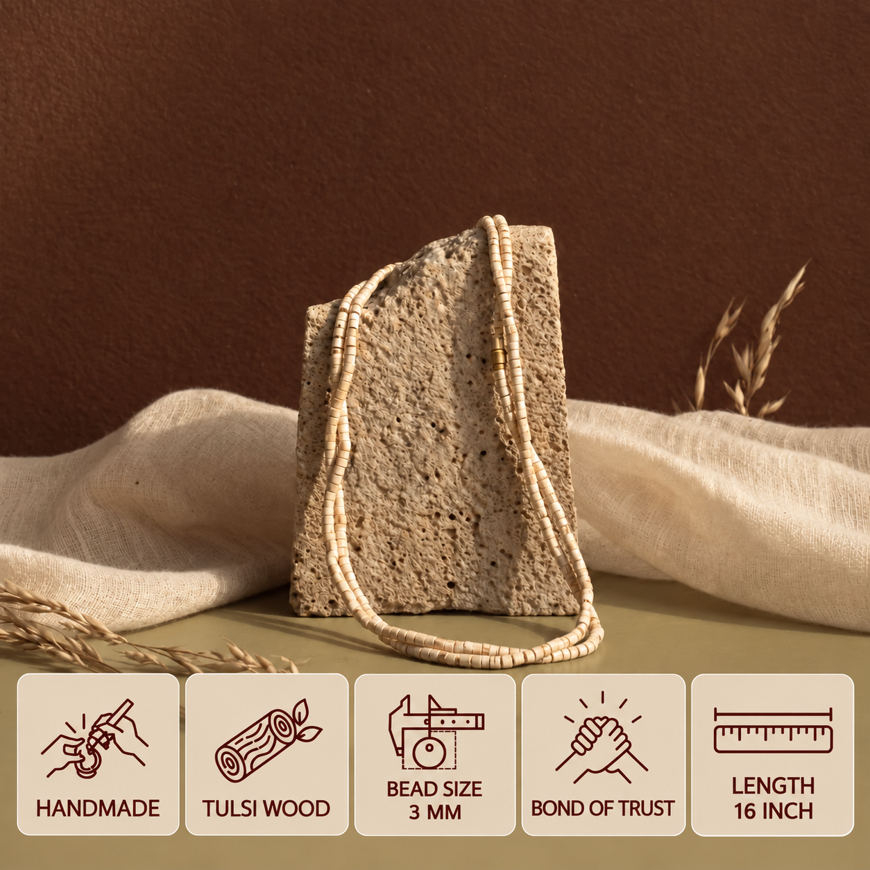 Tulsi mala with small 3 mm beads draped over a stone display, with feature cards showing its 16 inch length.
