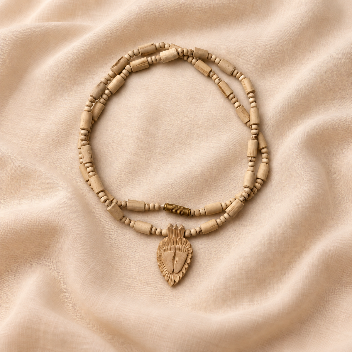 Tulsi mala with cylindrical wooden beads, a carved Charan Paduka pendant and a gold-coloured clasp
