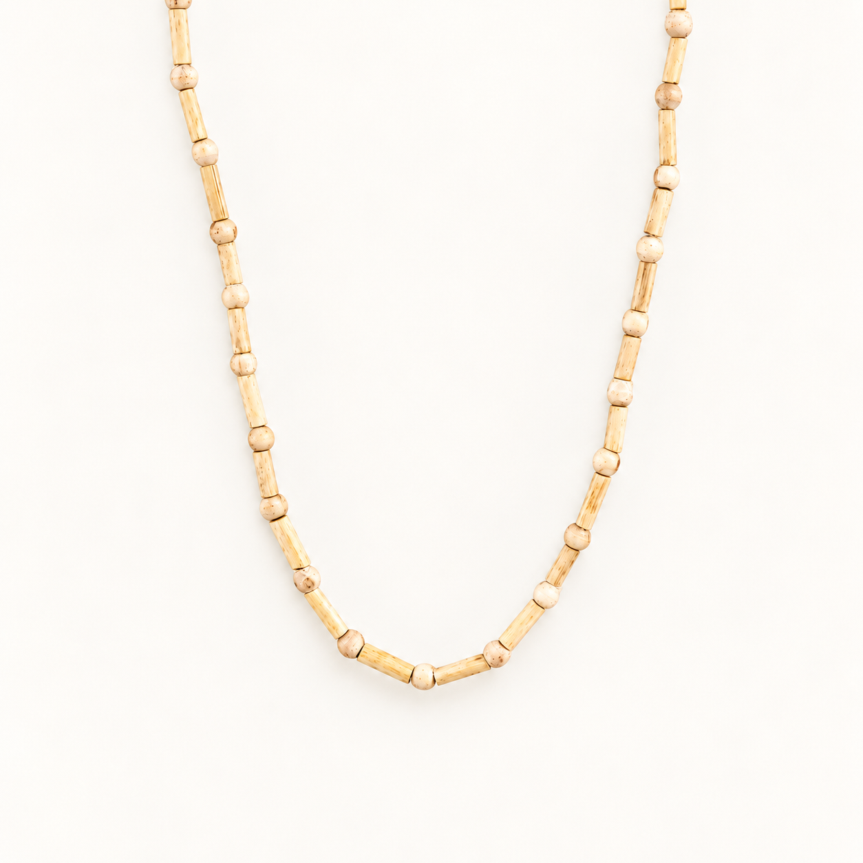 Tulsi wood mala with alternating cylindrical and round beads in a V shape on an off-white background.