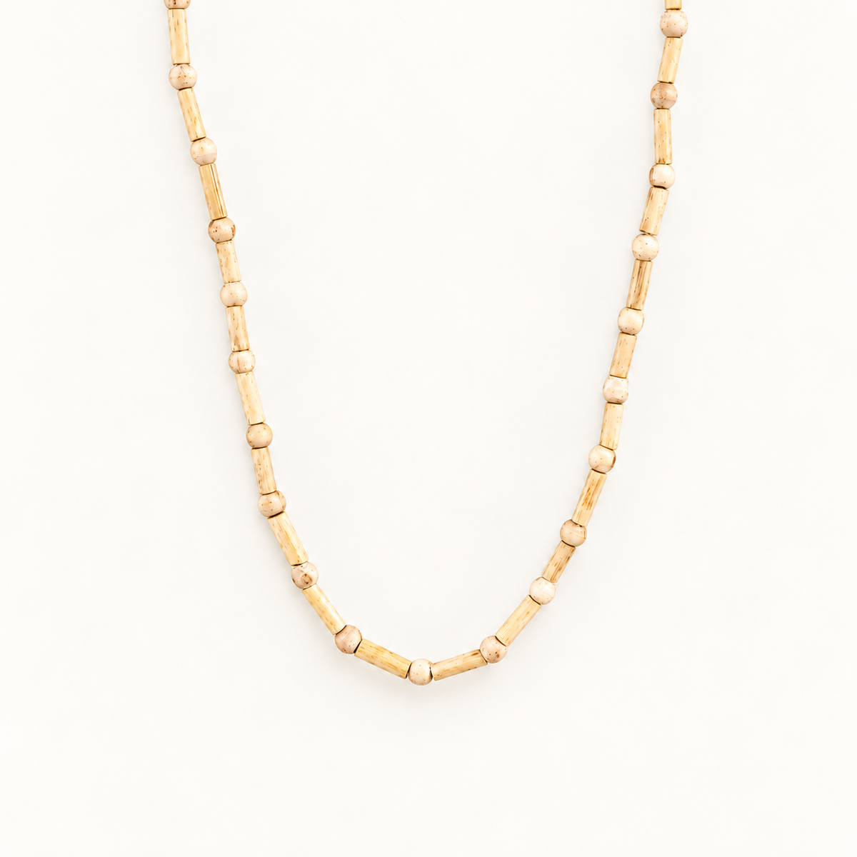 Tulsi wood mala with alternating cylindrical and round beads in a V shape on an off-white background.