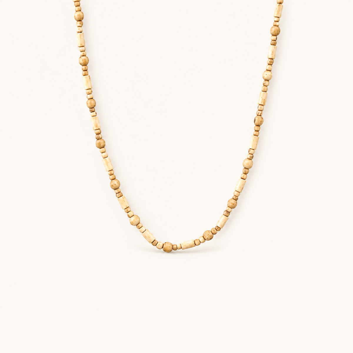 Tulsi mala with alternating round and cylindrical wooden beads on an off-white background.