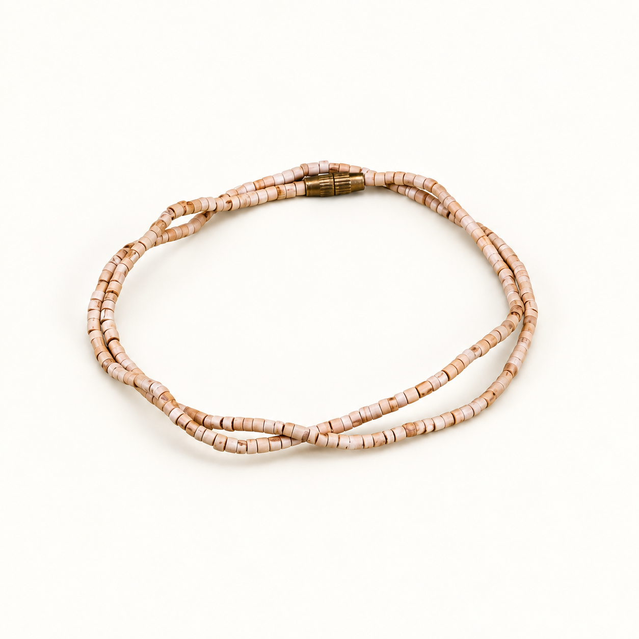 Tulsi mala with small cylindrical wooden beads and a gold-colored screw clasp arranged on an off-white background.