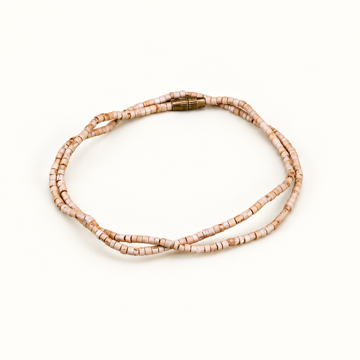 Tulsi mala with small cylindrical wooden beads and a gold-colored screw clasp arranged on an off-white background.