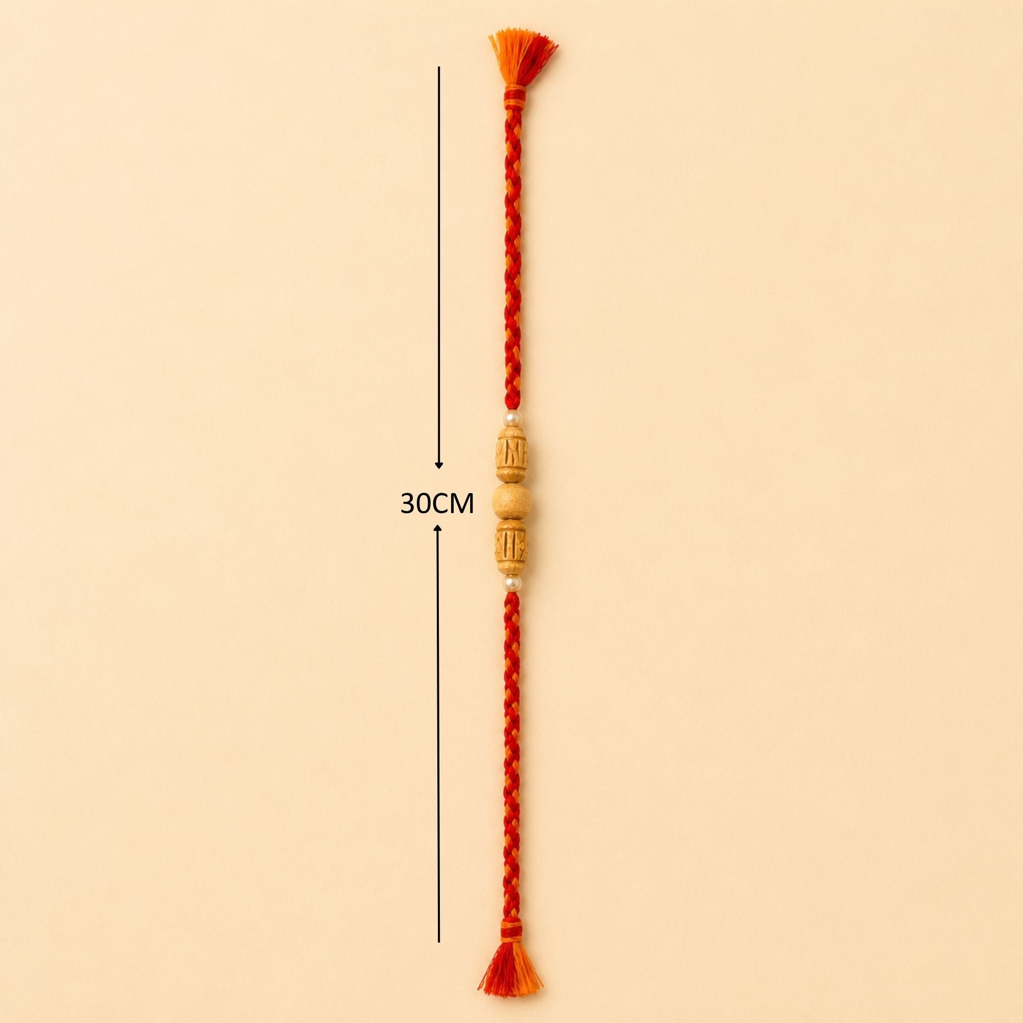 30 cm length for the handcrafted Tulsi and pearl beaded Rakhi with red and orange braided thread.