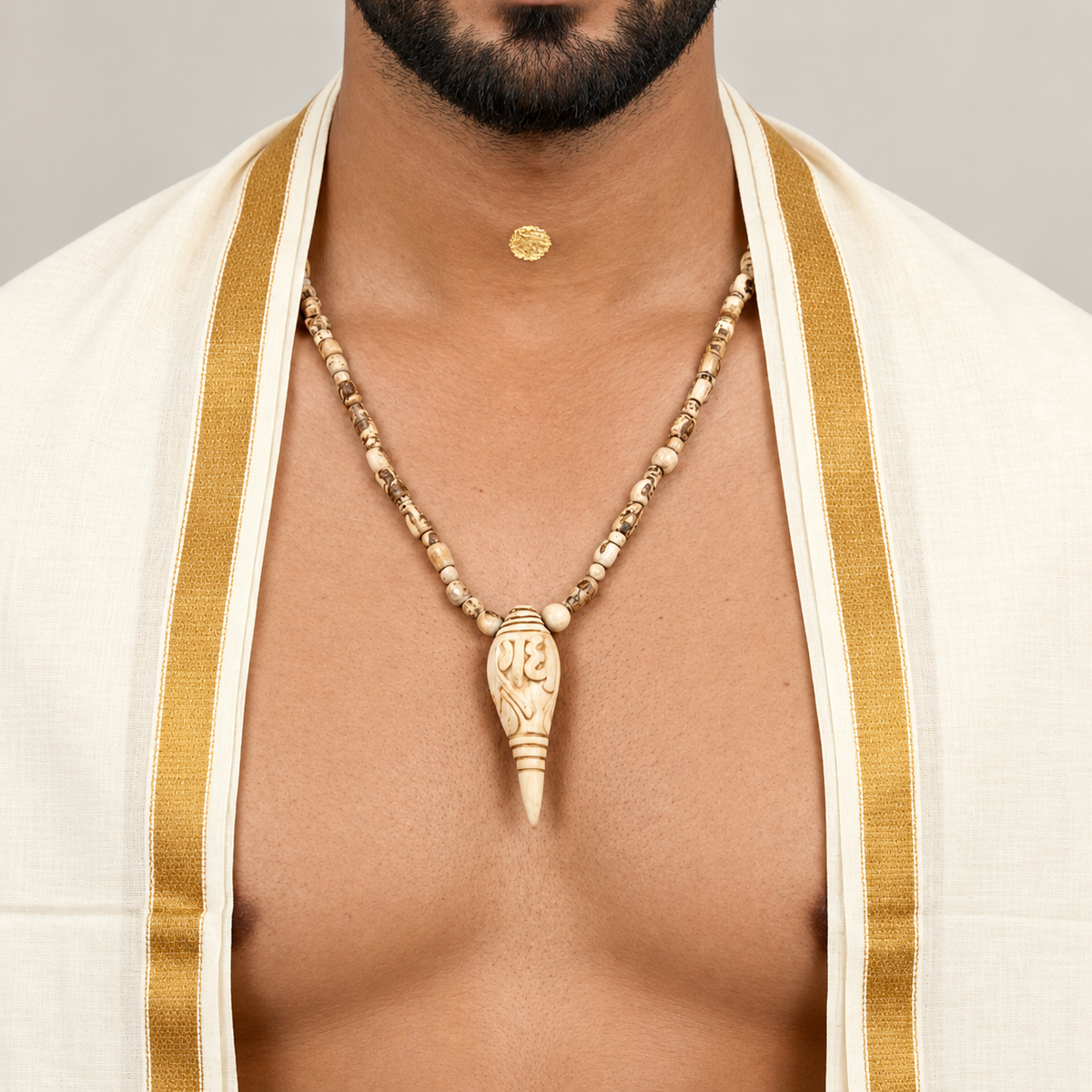 Man wearing natural Tulsi pendant mala with carved Tulsi beads and conch-shaped pendant