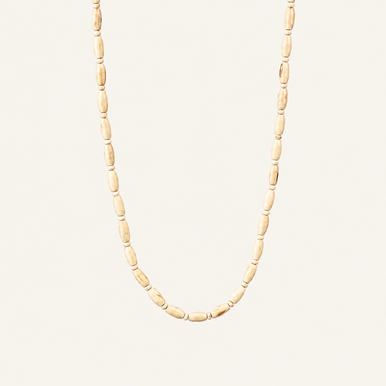 Off-white background par natural wood grain wali Tulsi bead mala.