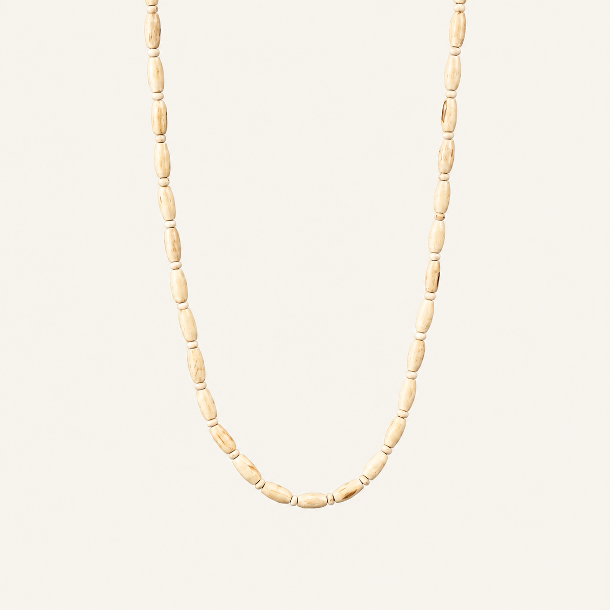 Off-white background par natural wood grain wali Tulsi bead mala.