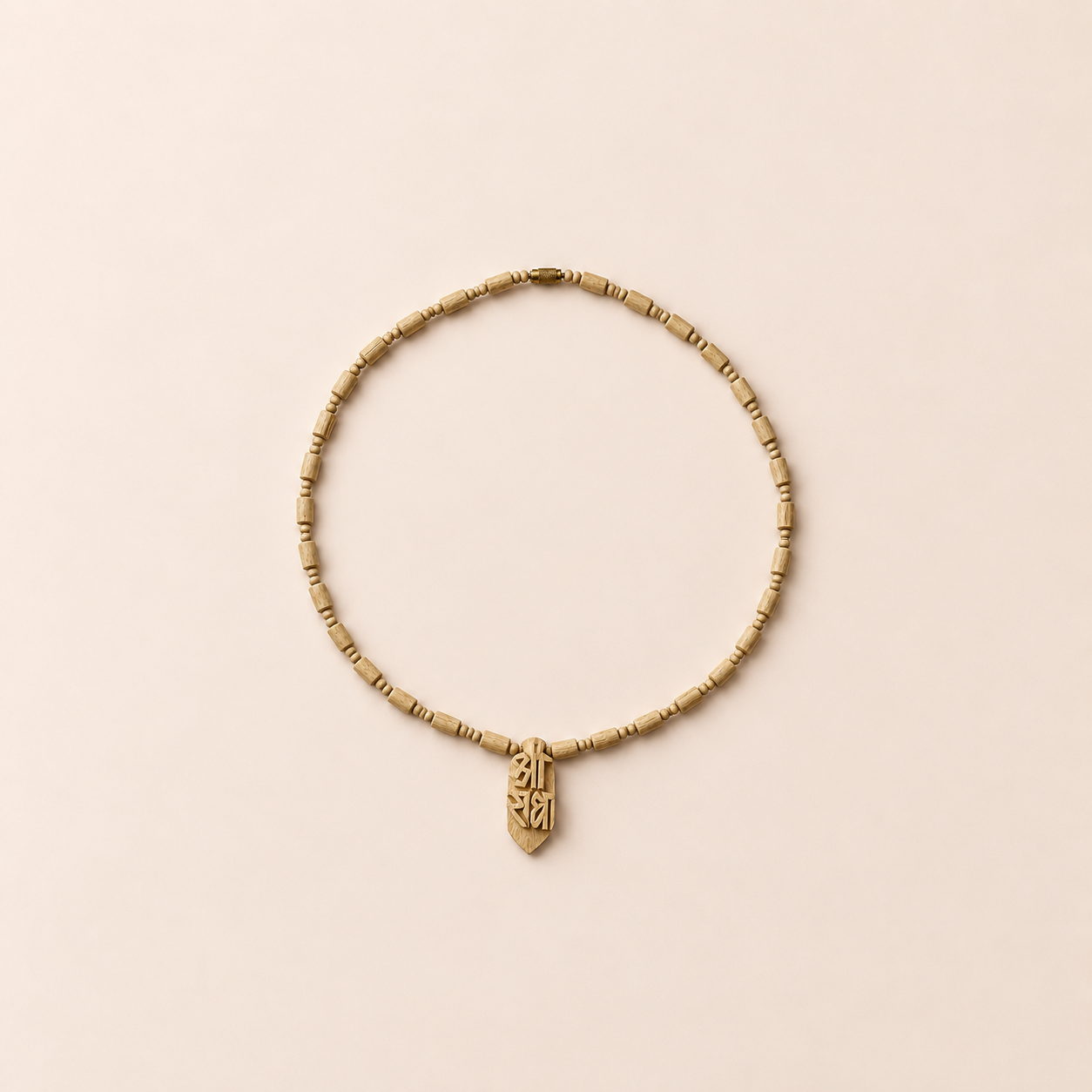Natural Tulsi wood mala necklace with cylindrical wooden beads and carved wooden pendant arranged on a soft pastel background.