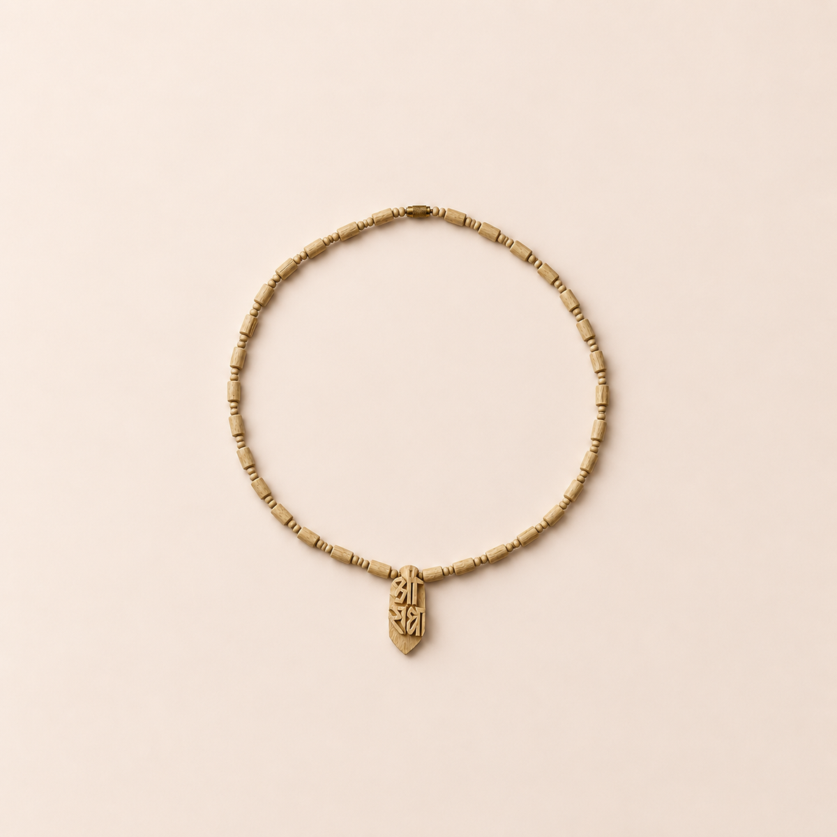 Natural Tulsi wood mala necklace with cylindrical wooden beads and carved wooden pendant arranged on a soft pastel background.