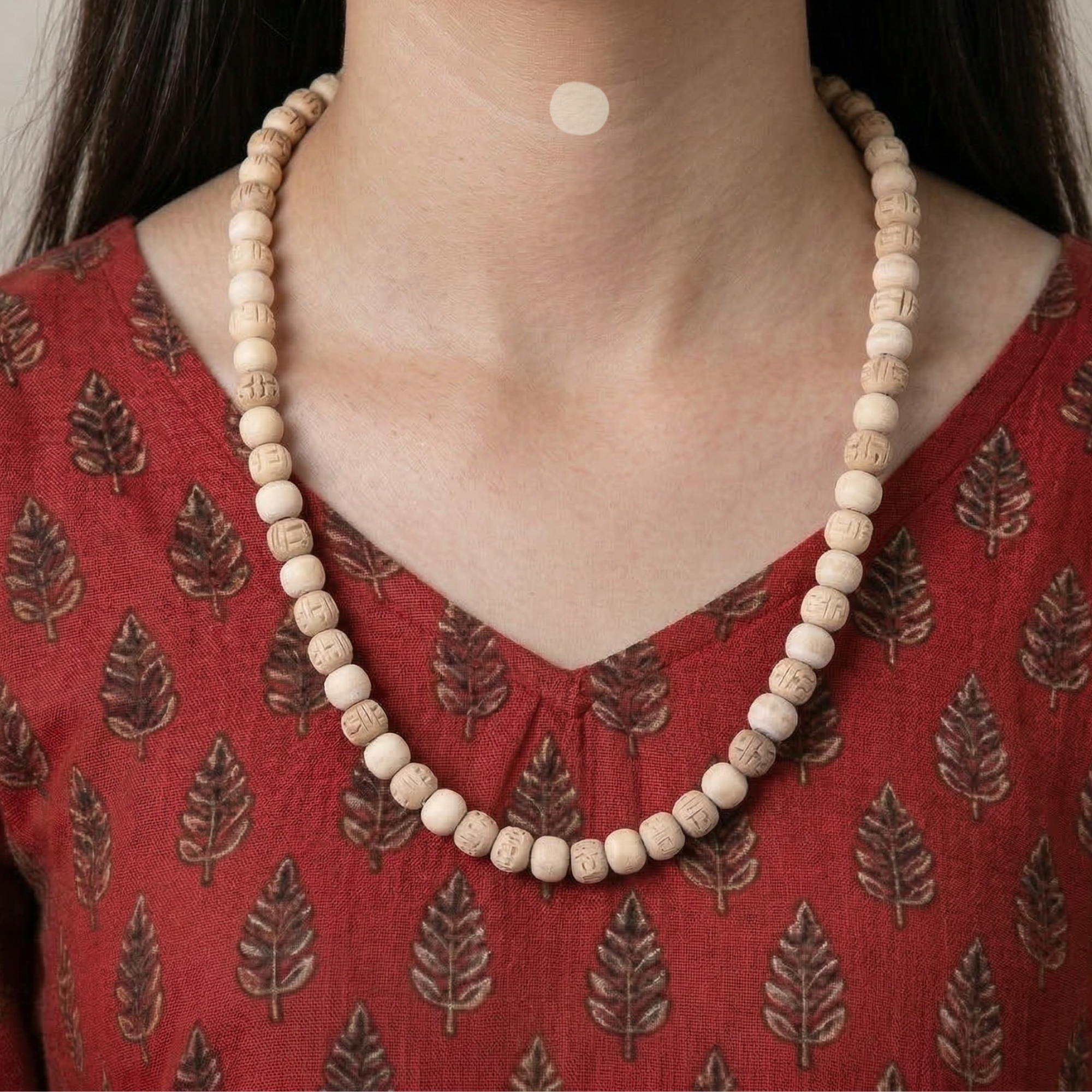 Woman wearing an original Tulsi kanthi mala with a unique alternating carved bead design