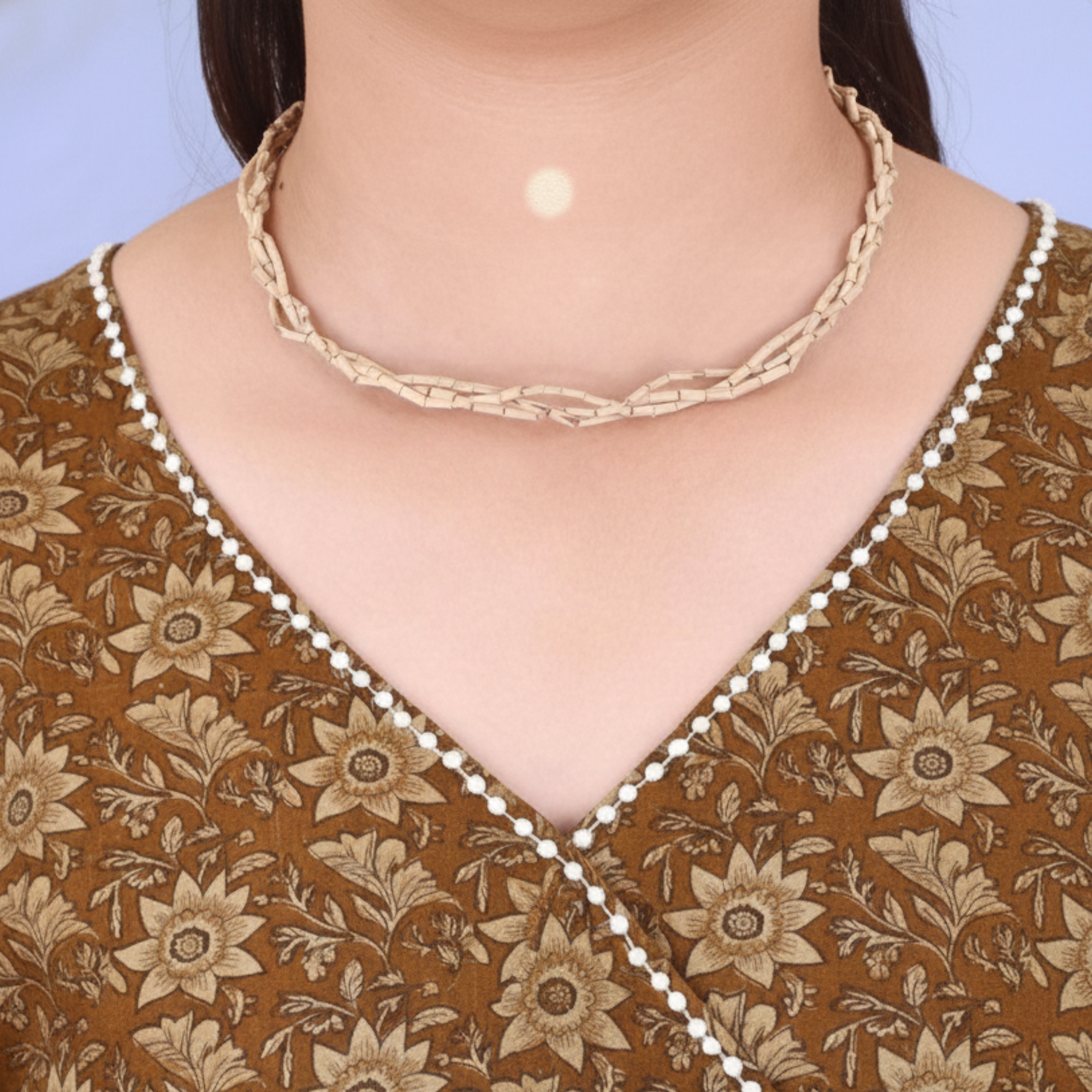 Woman wearing a traditional multi strand Vaishnav Tulsi Kanthi Mala with natural raw small wood beads