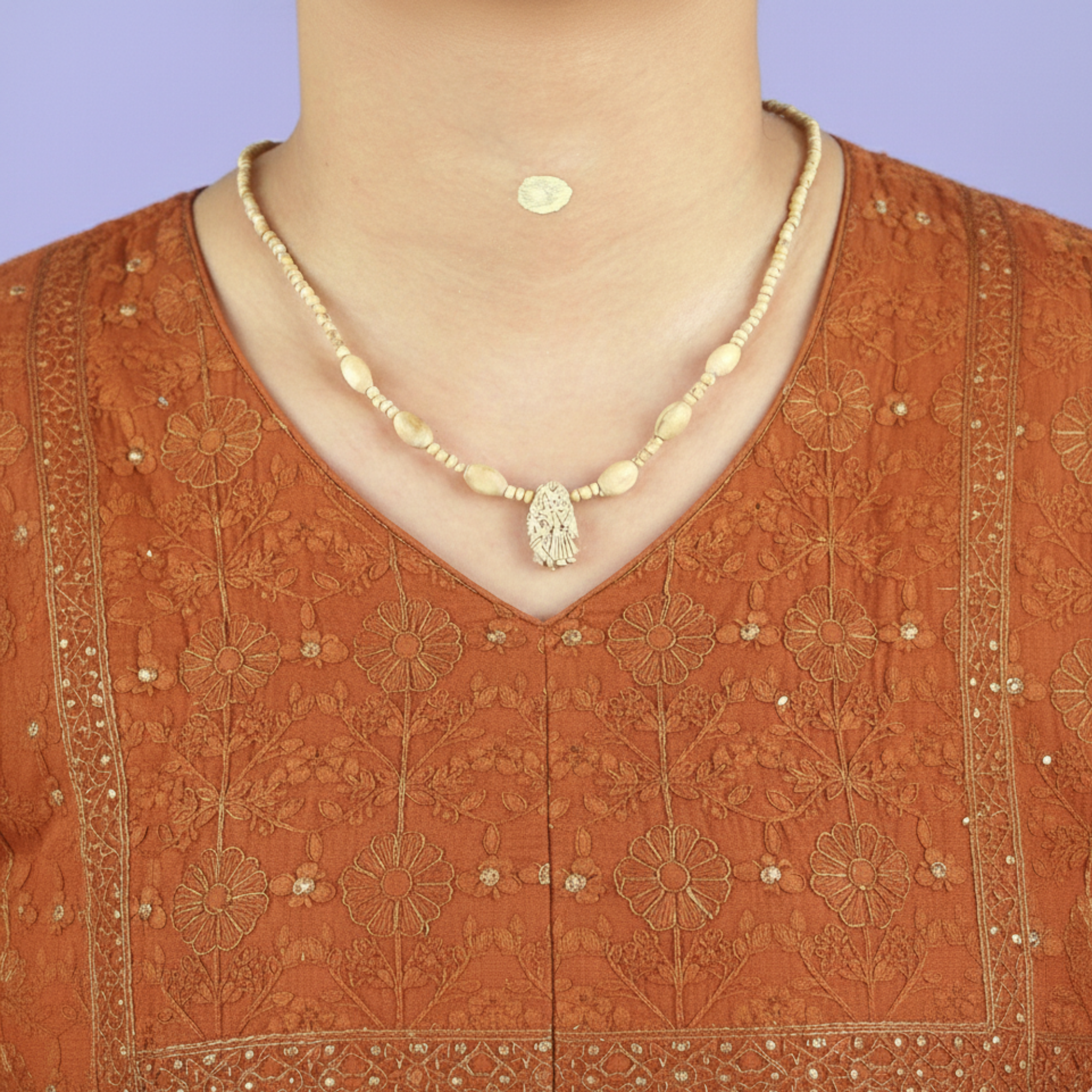 Woman wearing an original Vrindavan Tulsi Kanthi Mala with a carved Radha Krishna wooden pendant