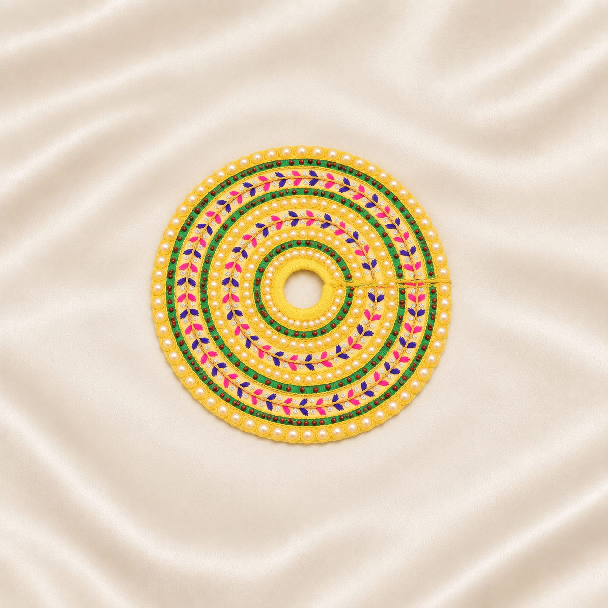 Yellow pearl-embroidered Laddu Gopal dress with green, pink and purple floral beadwork.