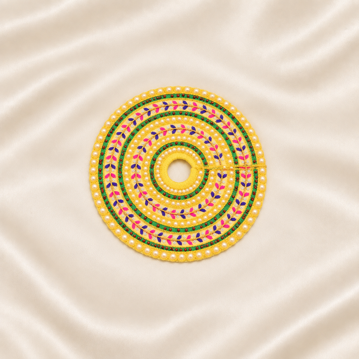 Yellow pearl-embroidered Laddu Gopal dress with green, pink and purple floral beadwork.