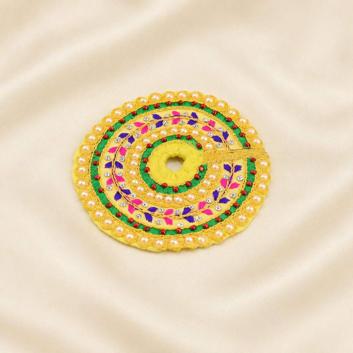Yellow pearl-embroidered Laddu Gopal dress with green, pink and purple floral beadwork.